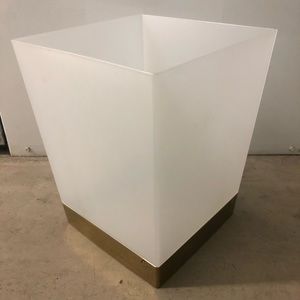 Plastic white and gold trash bin